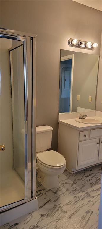 bathroom with vanity, toilet, and an enclosed shower