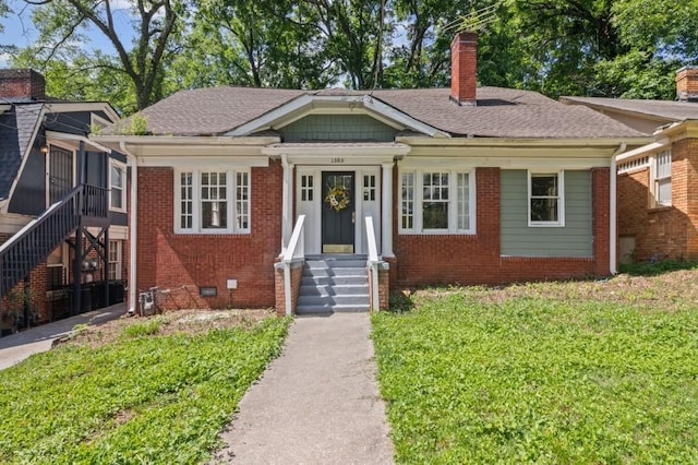 1585 Olympian Cir SW, Atlanta, GA 30310 - bungalow-style house with a chimney, entry steps, brick siding, and a front yard