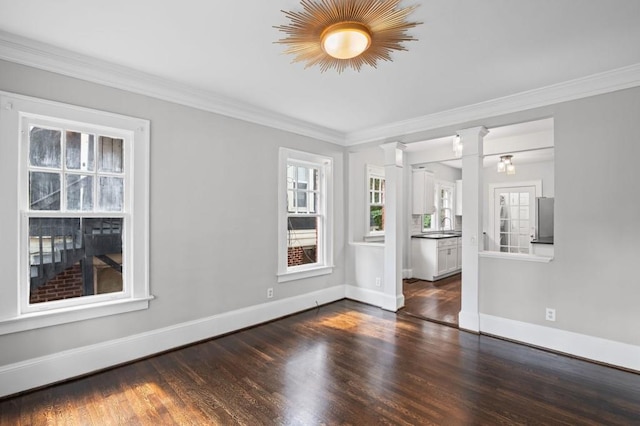1585 Olympian Cir SW, Atlanta, GA 30310 - unfurnished room with wood finished floors, healthy amount of natural light, ornamental molding, and decorative columns