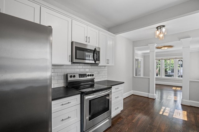 1585 Olympian Cir SW, Atlanta, GA 30310 - kitchen with appliances with stainless steel finishes, decorative columns, dark countertops, tasteful backsplash, and dark wood finished floors