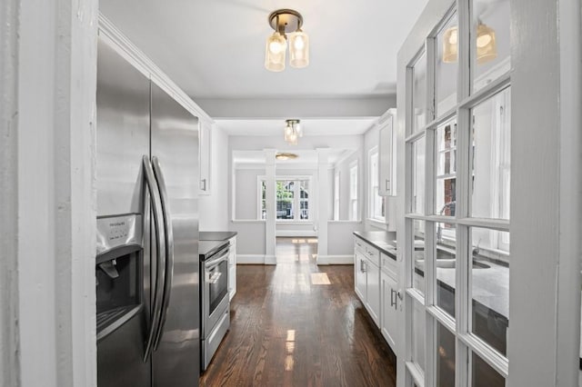 1585 Olympian Cir SW, Atlanta, GA 30310 - kitchen featuring appliances with stainless steel finishes, dark wood-type flooring, white cabinets, glass insert cabinets, and dark countertops