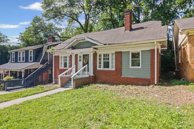 1585 Olympian Cir SW, Atlanta, GA 30310 - bungalow-style home with a chimney, brick siding, and a front lawn