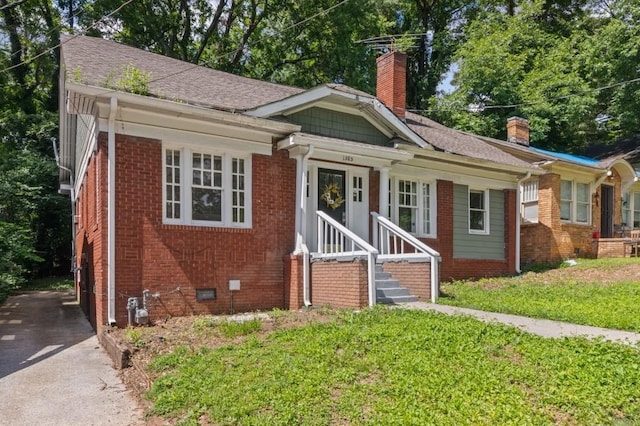 1585 Olympian Cir SW, Atlanta, GA 30310 - bungalow-style home with a chimney, brick siding, crawl space, and a front lawn