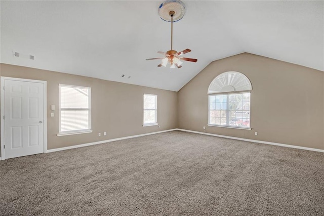 carpeted empty room featuring a ceiling fan, lofted ceiling, and baseboards