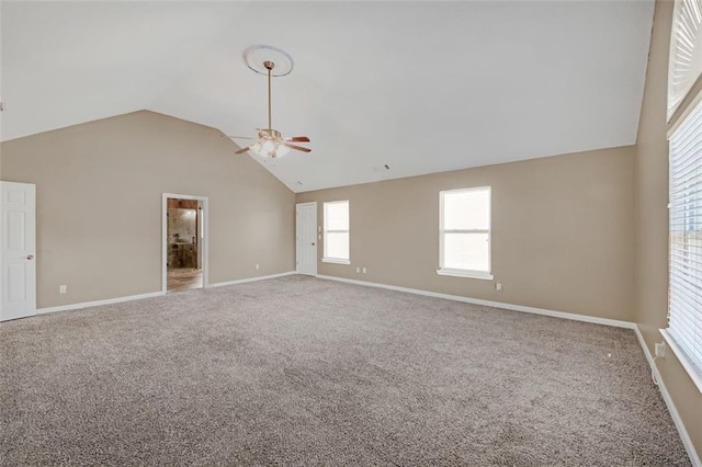 spare room featuring high vaulted ceiling, carpet, ceiling fan, and baseboards