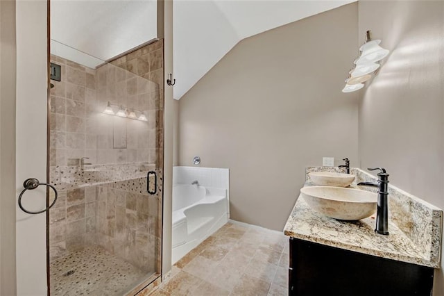 bathroom featuring a sink, a stall shower, a bath, and lofted ceiling