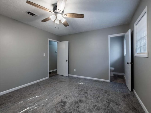 unfurnished bedroom with ceiling fan, carpet floors, visible vents, and baseboards