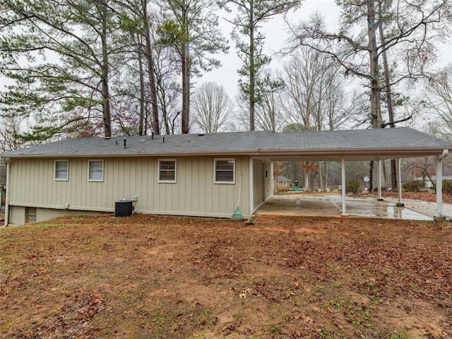 back of house featuring a carport and central air condition unit