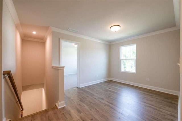 unfurnished room with crown molding, wood finished floors, baseboards, and recessed lighting