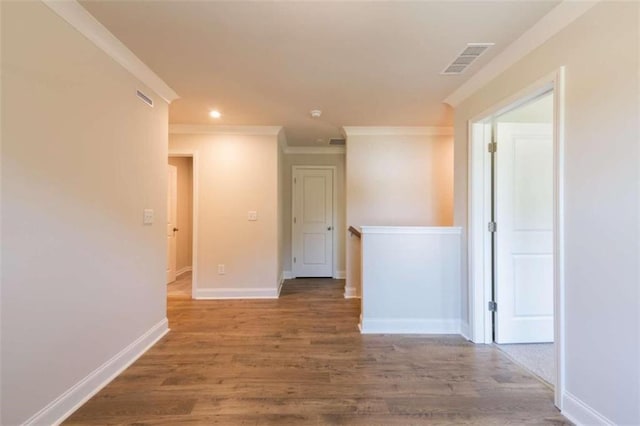 unfurnished room with ornamental molding and hardwood / wood-style floors