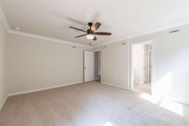 unfurnished bedroom with ornamental molding, light colored carpet, baseboards, and a ceiling fan