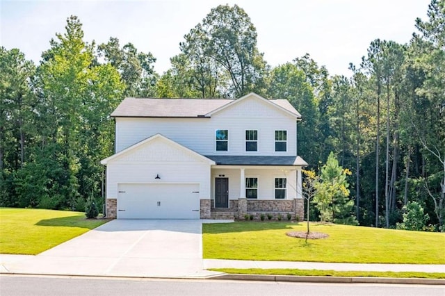view of front of house featuring driveway, a garage, a front lawn, and stone siding