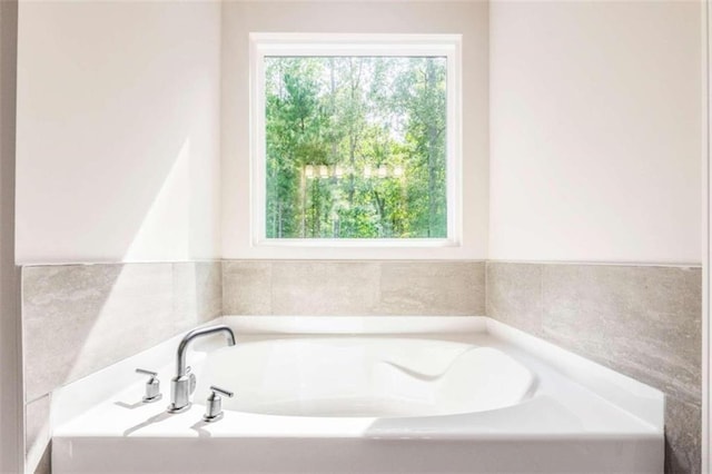 bathroom featuring tile walls and a washtub