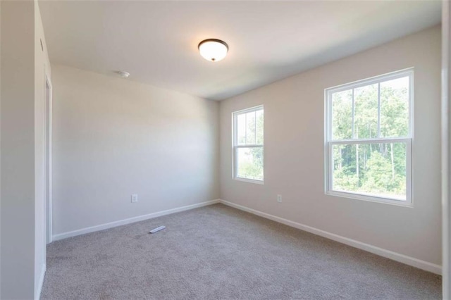 carpeted empty room with baseboards