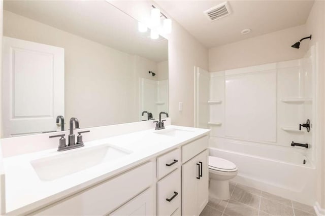 full bath featuring toilet, bathtub / shower combination, double vanity, and tile patterned floors