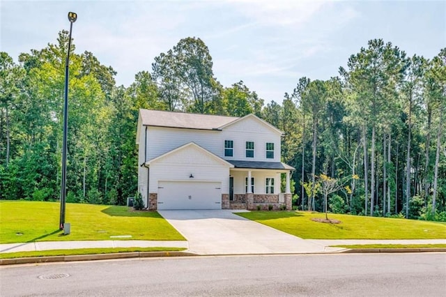view of front of property featuring a porch, a front lawn, driveway, and an attached garage