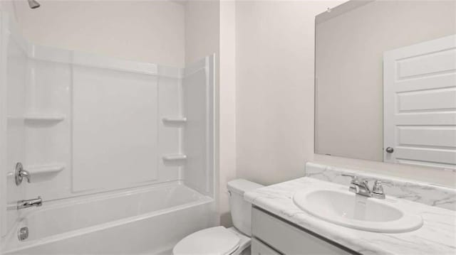 bathroom featuring toilet, vanity, and washtub / shower combination