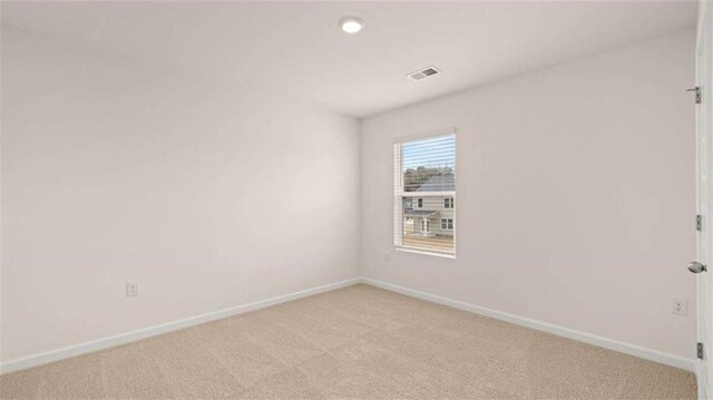 empty room featuring recessed lighting, visible vents, light colored carpet, and baseboards