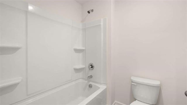 bathroom featuring tub / shower combination and toilet
