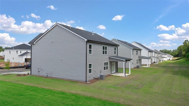 view of home's exterior featuring a yard, central air condition unit, and a residential view
