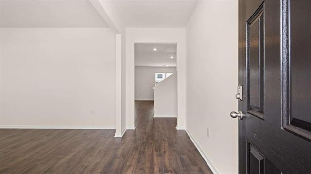 entryway with recessed lighting, dark wood-style floors, and baseboards