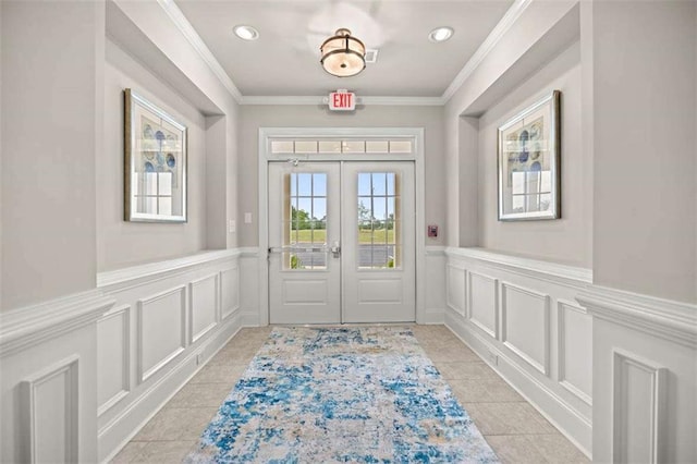 doorway with a decorative wall, french doors, and ornamental molding