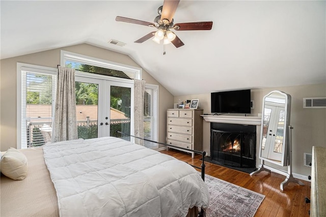 614 Cooledge Ave NE, Atlanta, GA 30306 - bedroom featuring access to exterior, french doors, vaulted ceiling, a warm lit fireplace, and wood finished floors