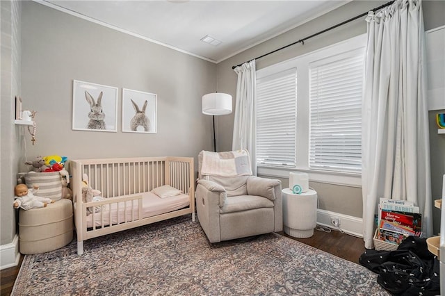 614 Cooledge Ave NE, Atlanta, GA 30306 - bedroom featuring a nursery area, ornamental molding, wood finished floors, and baseboards