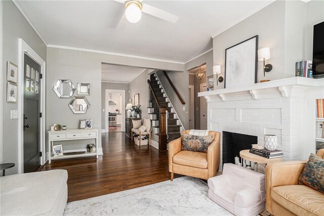 614 Cooledge Ave NE, Atlanta, GA 30306 - living area featuring a fireplace, stairs, crown molding, ceiling fan, and wood finished floors