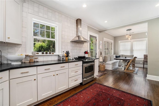 614 Cooledge Ave NE, Atlanta, GA 30306 - kitchen with wall chimney range hood, stainless steel gas range oven, dark wood-type flooring, dark countertops, and crown molding