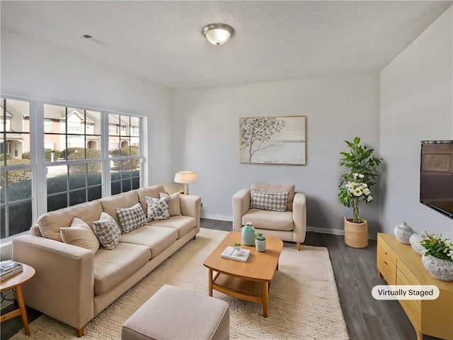 living area featuring baseboards and wood finished floors