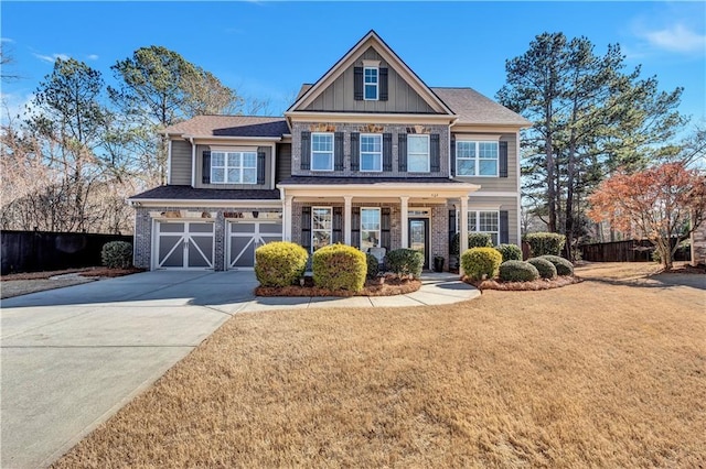 craftsman-style home featuring a garage, a porch, and a front yard