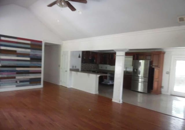 unfurnished living room with ceiling fan, high vaulted ceiling, dark hardwood / wood-style floors, and ornamental molding