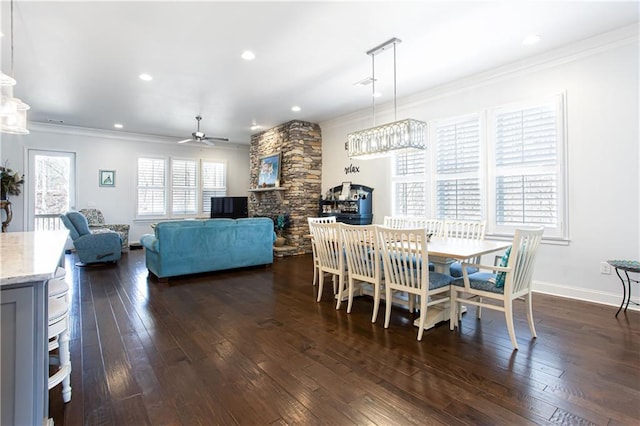 dining space featuring crown molding, baseboards, ceiling fan, dark wood finished floors, and recessed lighting