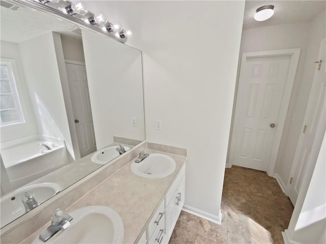 bathroom featuring double vanity and baseboards