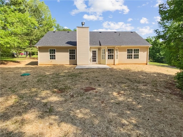 back of property featuring a patio area and a chimney