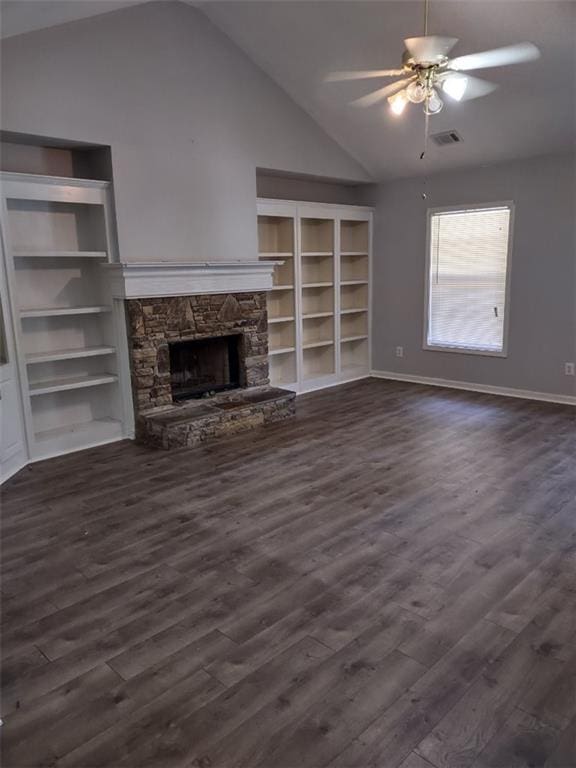 unfurnished living room with lofted ceiling, built in features, dark hardwood / wood-style flooring, ceiling fan, and a fireplace