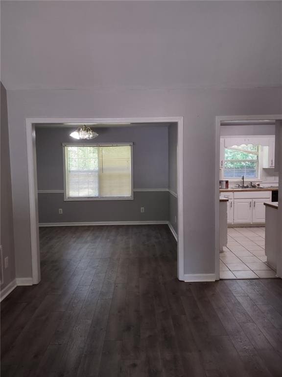 interior space featuring a notable chandelier, sink, and hardwood / wood-style floors