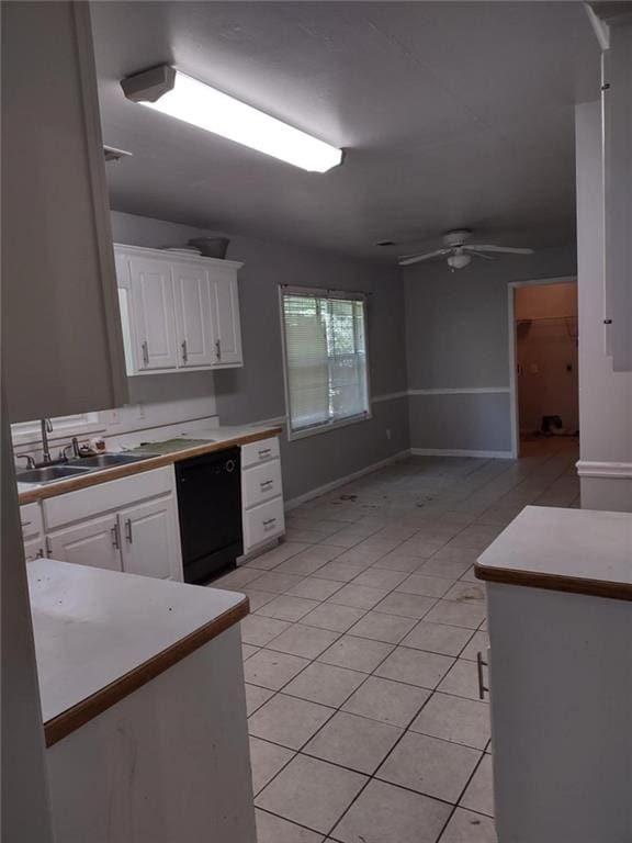 kitchen with white cabinetry, light tile patterned flooring, ceiling fan, sink, and black dishwasher