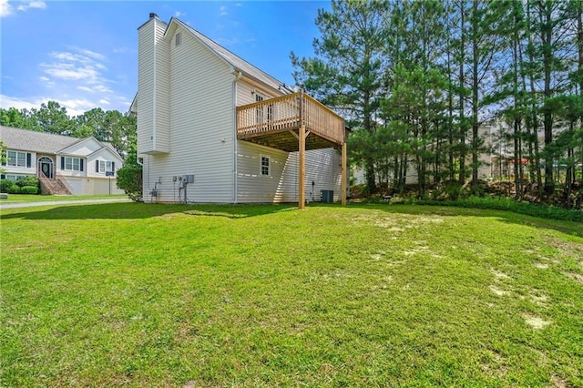 125 Fairhaven Trl, Fairburn, GA 30213 - rear view of house with a chimney, a deck, and a lawn