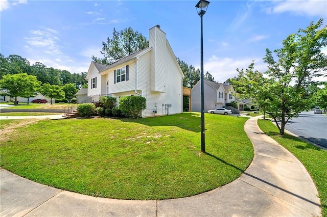 125 Fairhaven Trl, Fairburn, GA 30213 - view of home's exterior featuring a lawn and a chimney