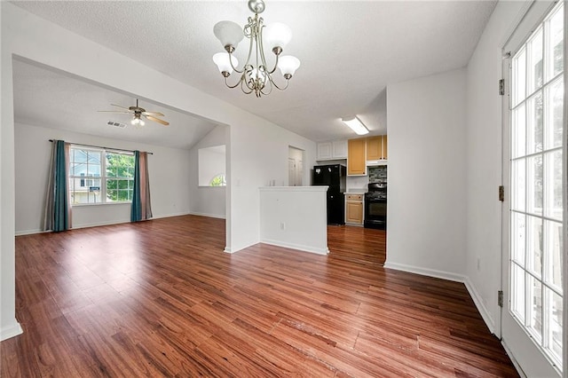 125 Fairhaven Trl, Fairburn, GA 30213 - unfurnished living room with wood finished floors, a chandelier, a ceiling fan, baseboards, and vaulted ceiling