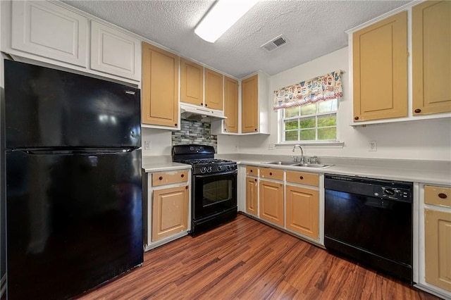 125 Fairhaven Trl, Fairburn, GA 30213 - kitchen featuring black appliances, a sink, light countertops, under cabinet range hood, and dark wood-type flooring