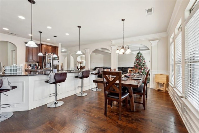 dining space featuring dark wood-style floors, arched walkways, visible vents, and recessed lighting