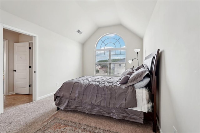 carpeted bedroom with lofted ceiling, visible vents, and baseboards