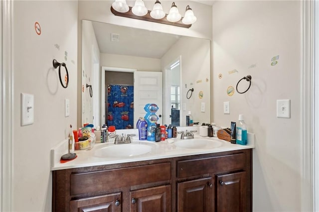 full bath featuring double vanity and a sink