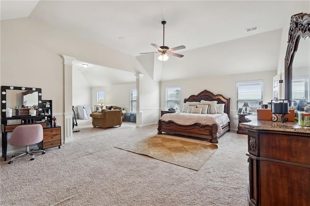 bedroom featuring baseboards, visible vents, light colored carpet, lofted ceiling, and ornate columns