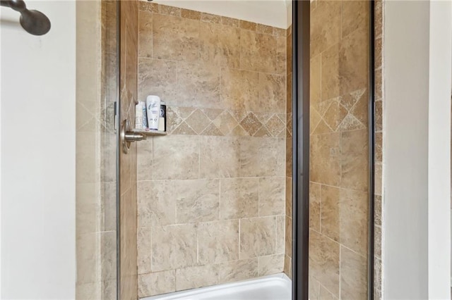 bathroom with a tile shower