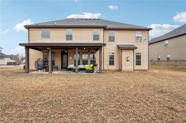 rear view of house featuring a patio area, outdoor lounge area, and a lawn