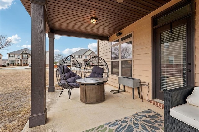 view of patio / terrace featuring a residential view and a fire pit